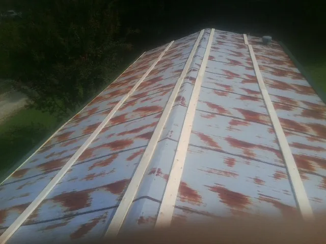 Rusted metal roof panels with new wood purlins before replacement — Storm Damage Roof Repair in Dayton by Roofing Brothers